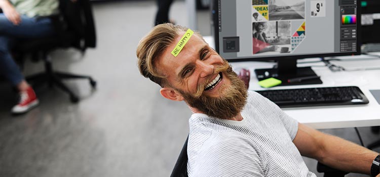 head image internal communication man at his desk smiling